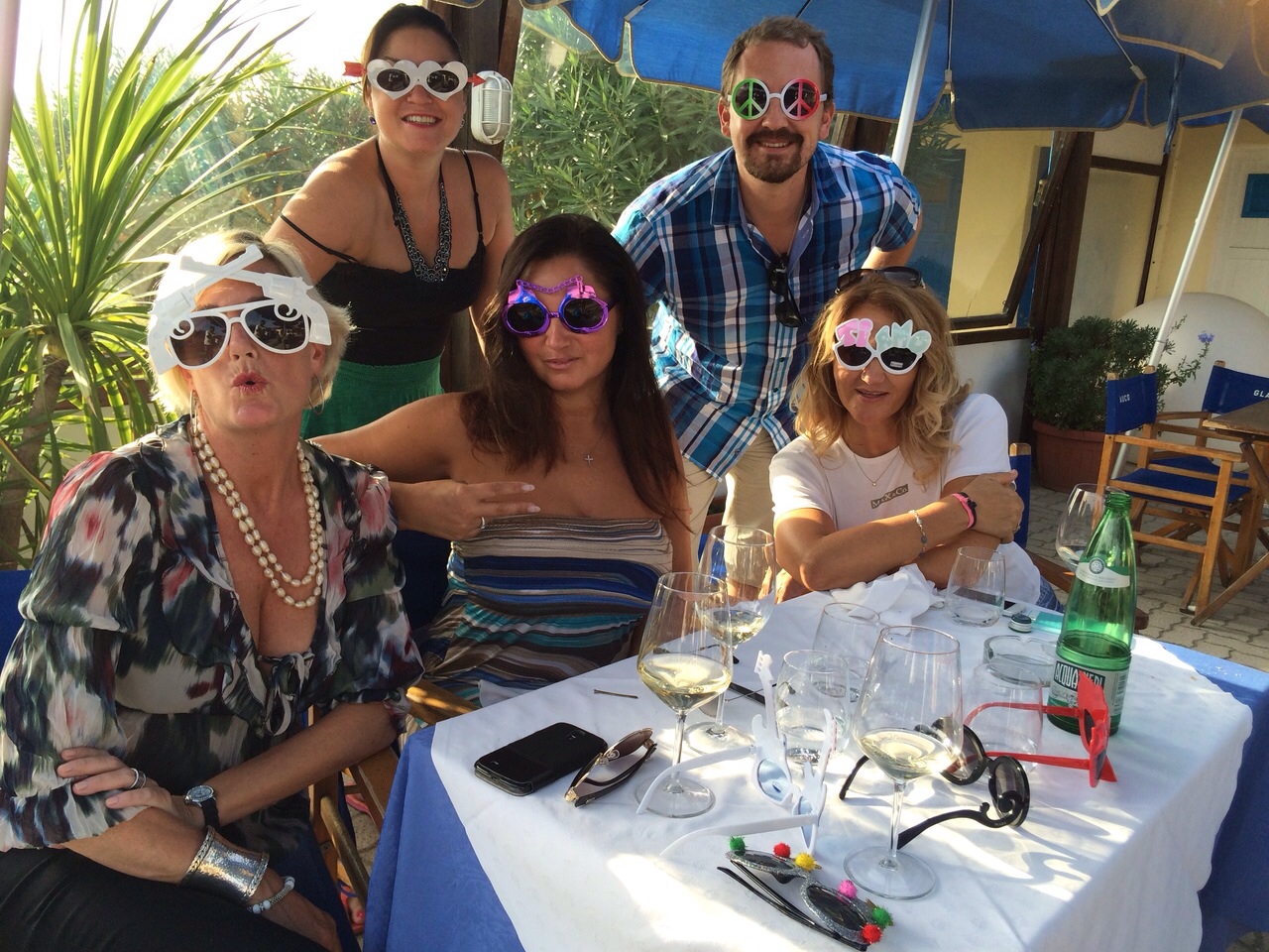 Group celebrating at a seaside restaurant in Italy