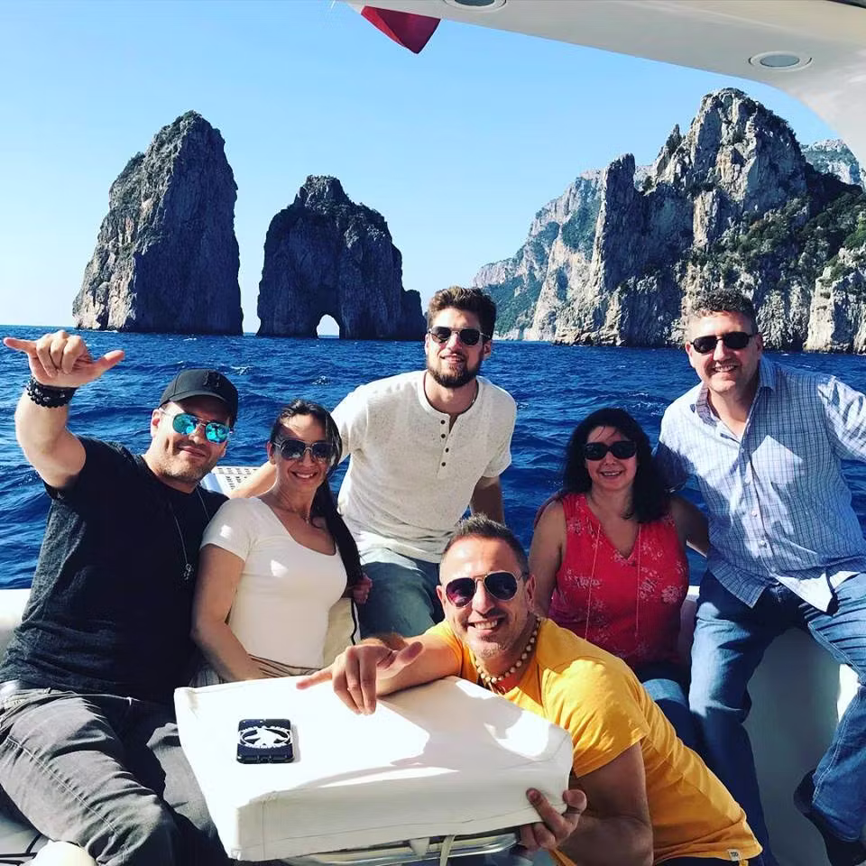 Private boat charter cruising along Amalfi Coast with swimming stops and coastal views
