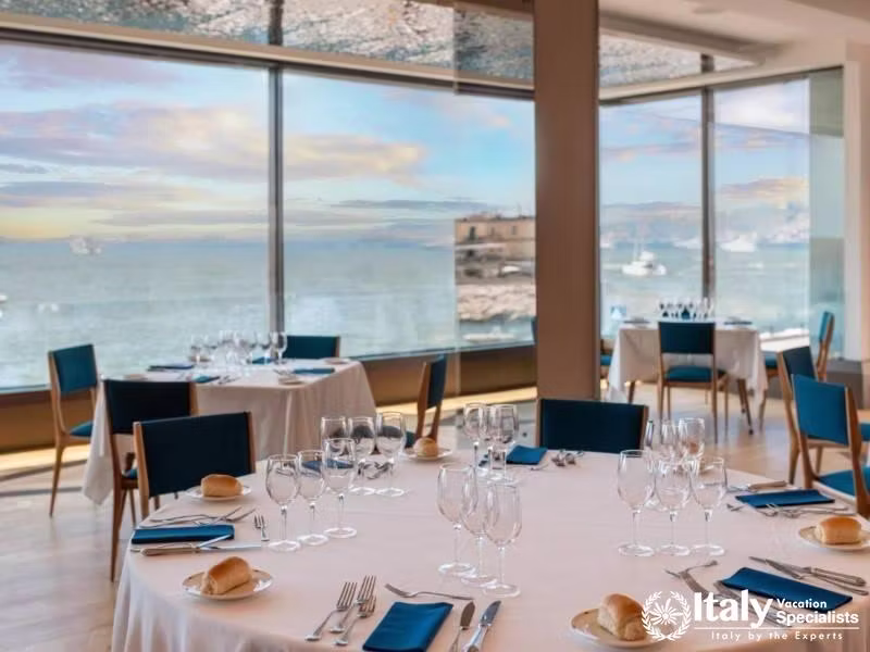 A dining area with stunning sea views and elegant table settings.