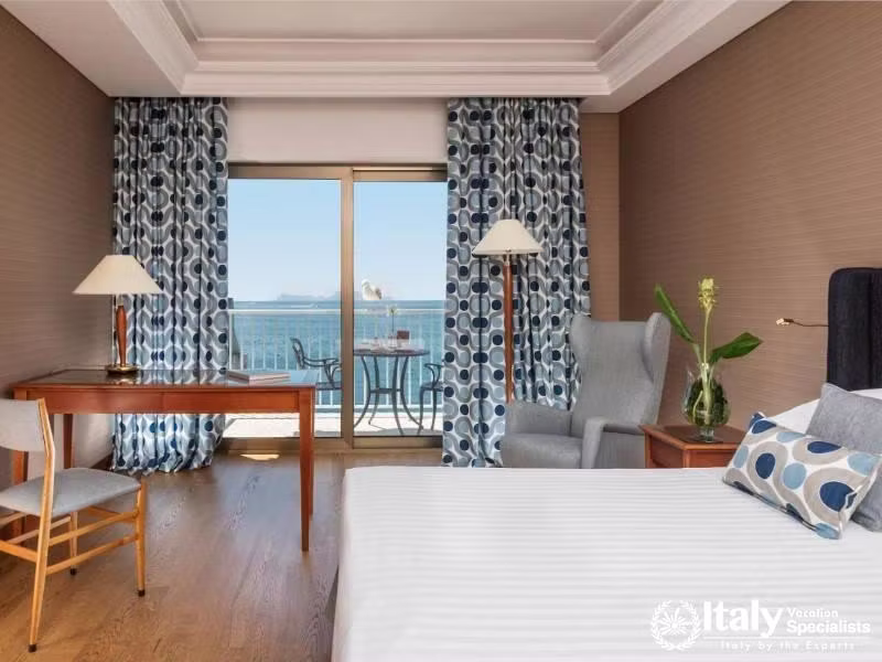 A stylish room featuring a sea-facing balcony and contemporary furnishings.