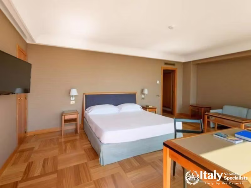A cozy, simply decorated bedroom with modern furnishings.