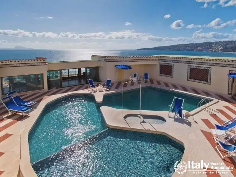 A rooftop pool area with stunning views of the sea.