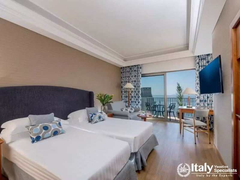 A bright and spacious twin room with ocean views and modern decor.