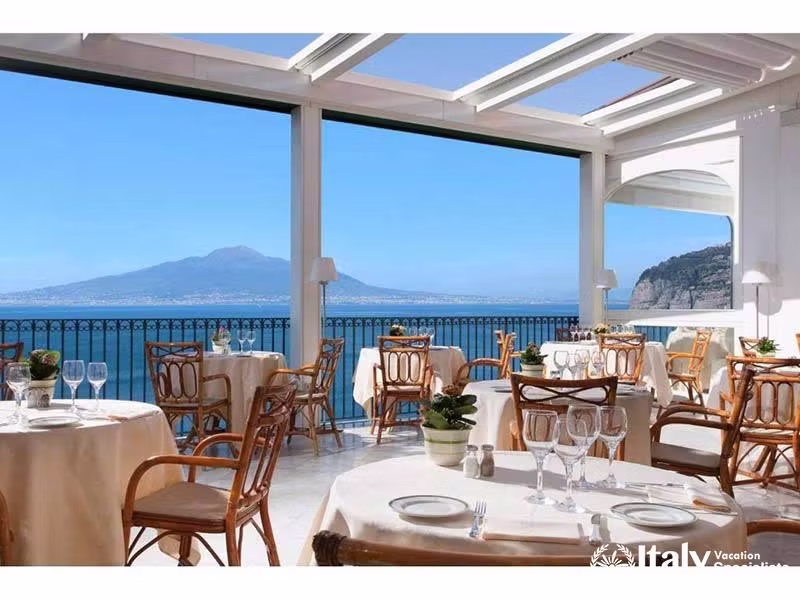 Bright dining area overlooking the sea and Mount Vesuvius.