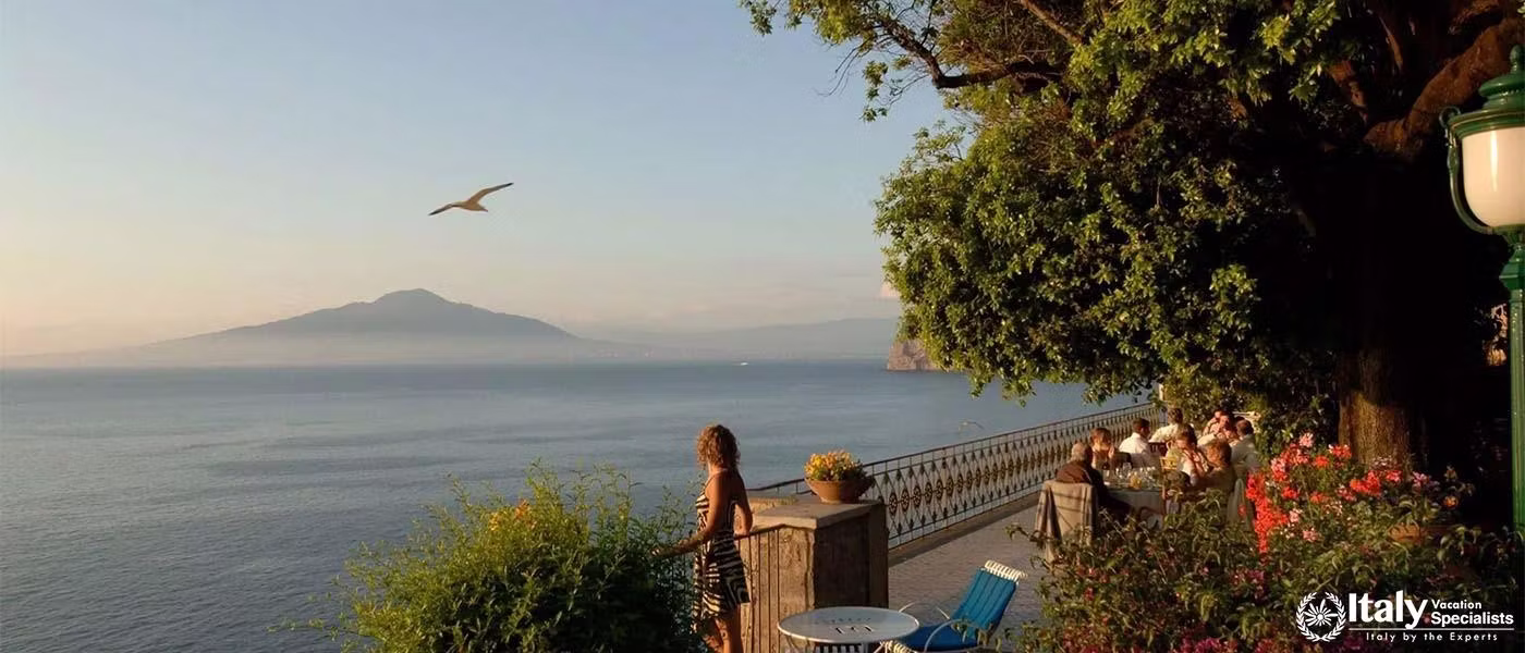 Panoramic terrace dining with views of Mount Vesuvius and the Gulf.