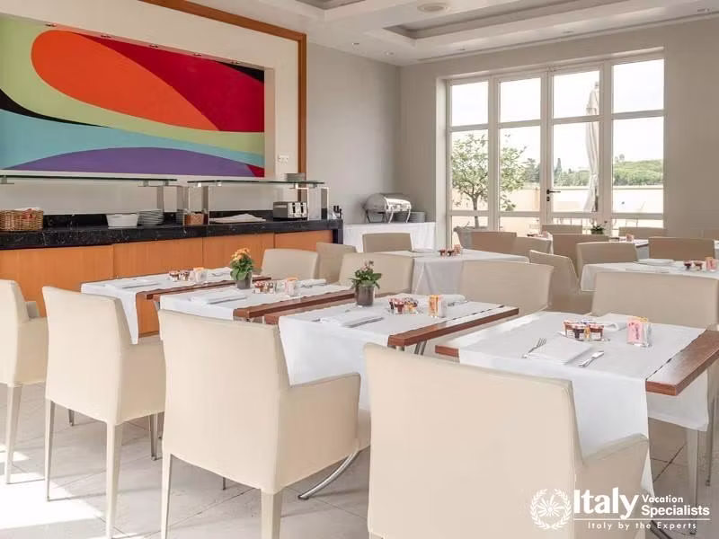 A bright and modern dining area with artistic accents at Hotel Capo dAfrica.