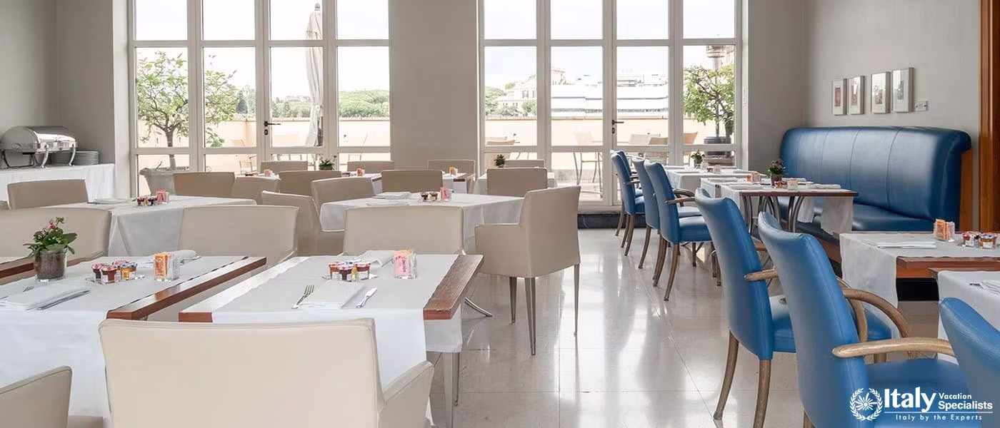 An elegant indoor dining space bathed in natural light with a modern aesthetic at Hotel Capo d'Afric