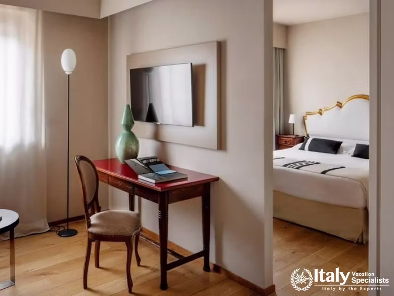 Well-lit room featuring a stylish desk setup, ideal for business or leisure.