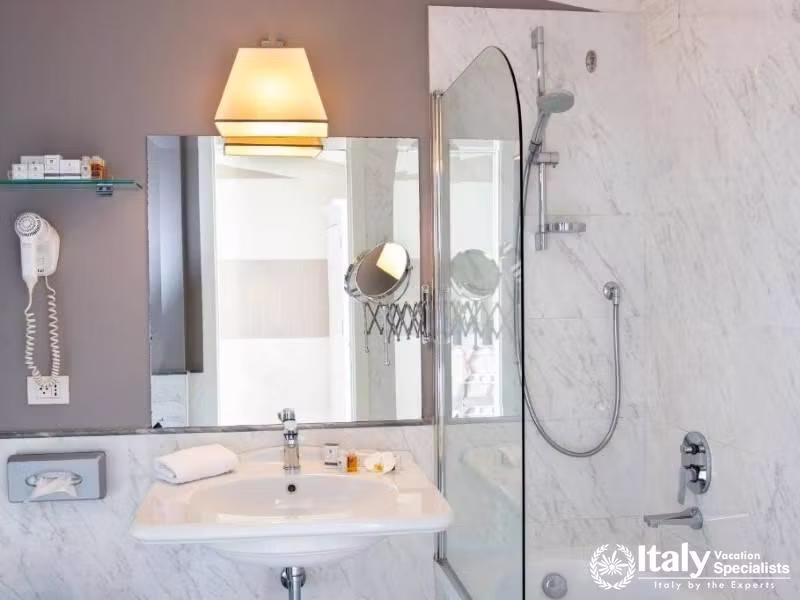 Chic Venetian Bathroom, Marble Elegance in Hotel Rapallo Florence