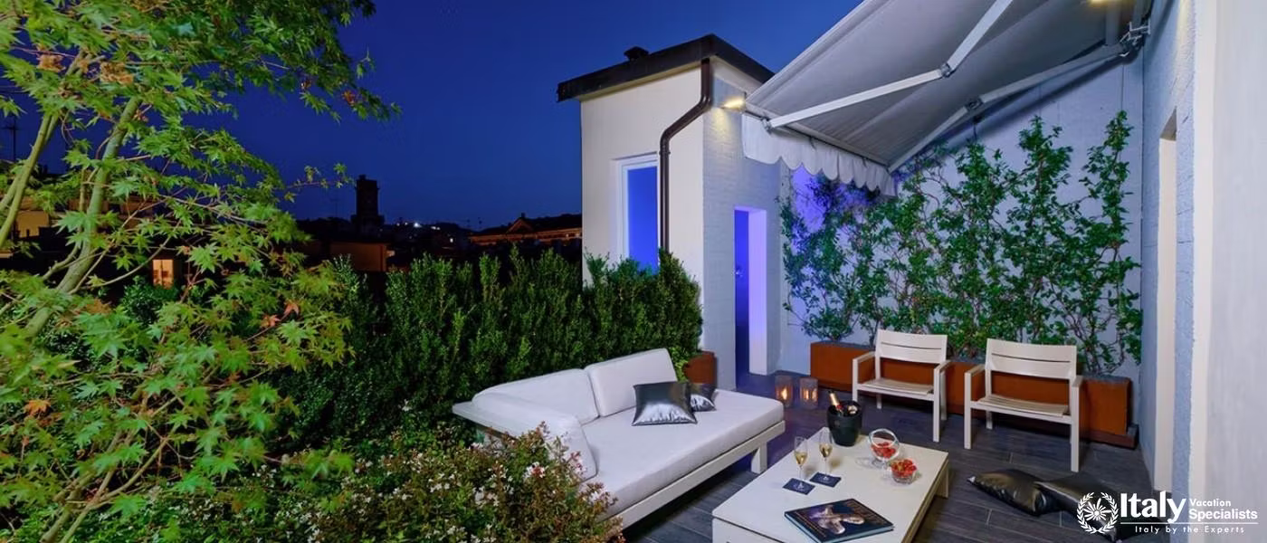 Unwind in the serene outdoor lounge surrounded by lush greenery and urban charm.