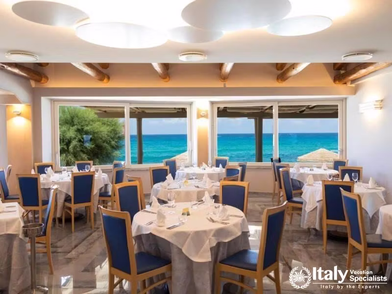 Dine with a view at Villaggio Il Gabbianos restaurant overlooking the sea.