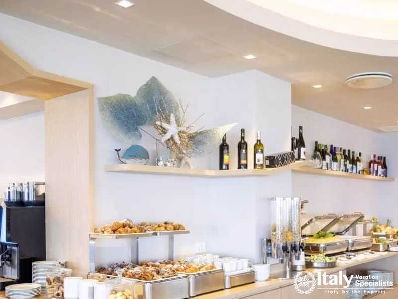 The buffet at Villaggio Il Gabbiano serves a spread of delights under elegant lighting.