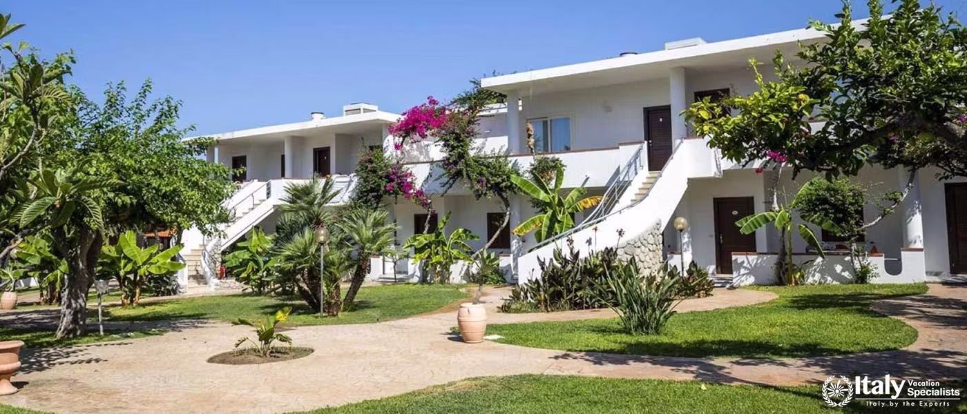 Lush gardens frame the white-washed villas of Villaggio Il Gabbiano