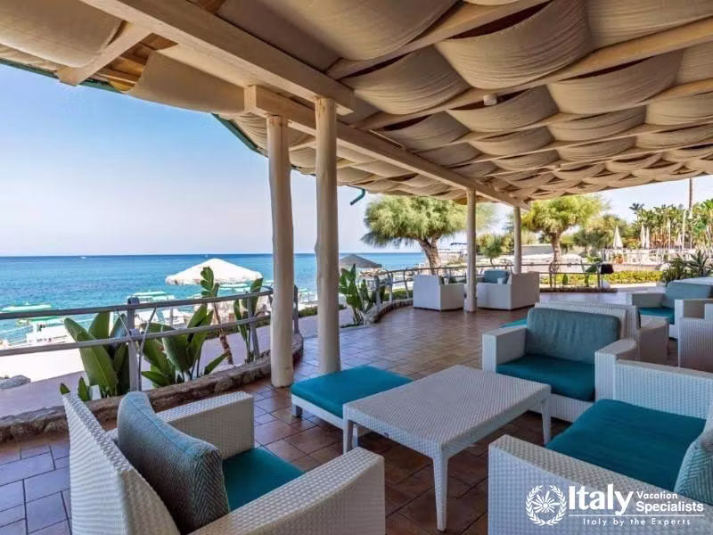 The shaded veranda with sea views offers a perfect spot to unwind at Villaggio Il Gabbiano.