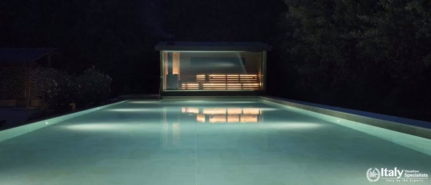Elegant outdoor pool under nighttime lights at QC Termeroma Spa and Resort.