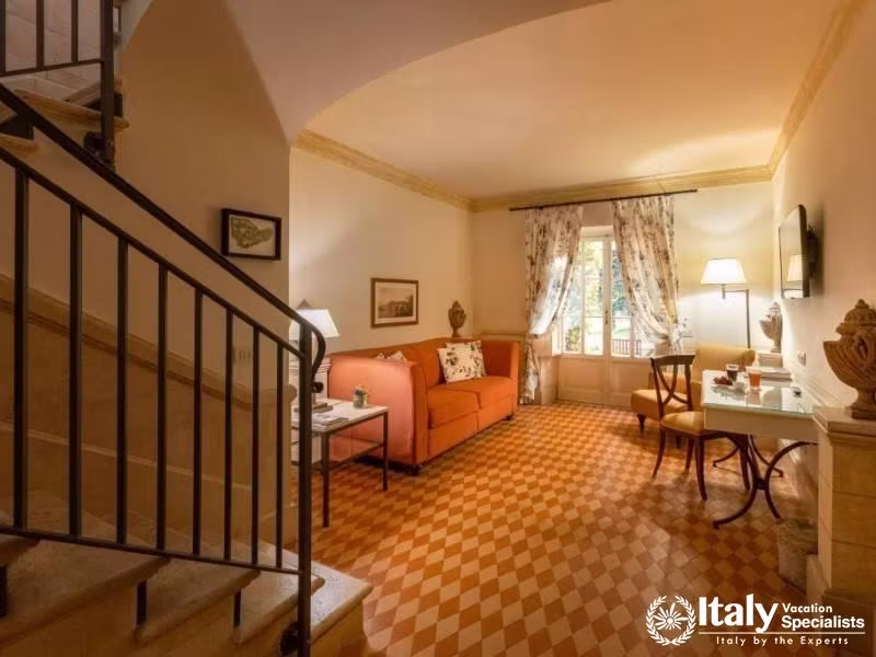 Two-level suite featuring a cozy sitting area and charming decor at QC Termeroma Spa and Resort