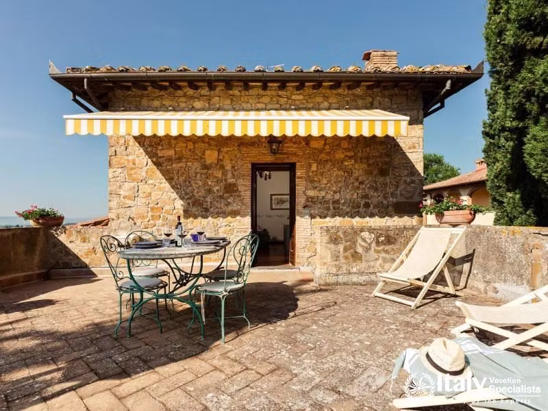 Enjoy a delightful meal on our sunlit terrace, complete with comfortable seating and a charming awni