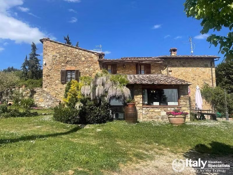 A charming stone farmhouse amidst lush gardens at SantAgnese Farm.
