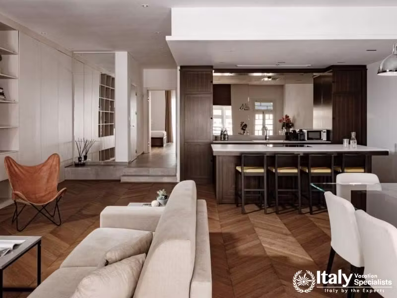 A spacious open-plan living area with a modern kitchen, comfortable seating, and tasteful decor.