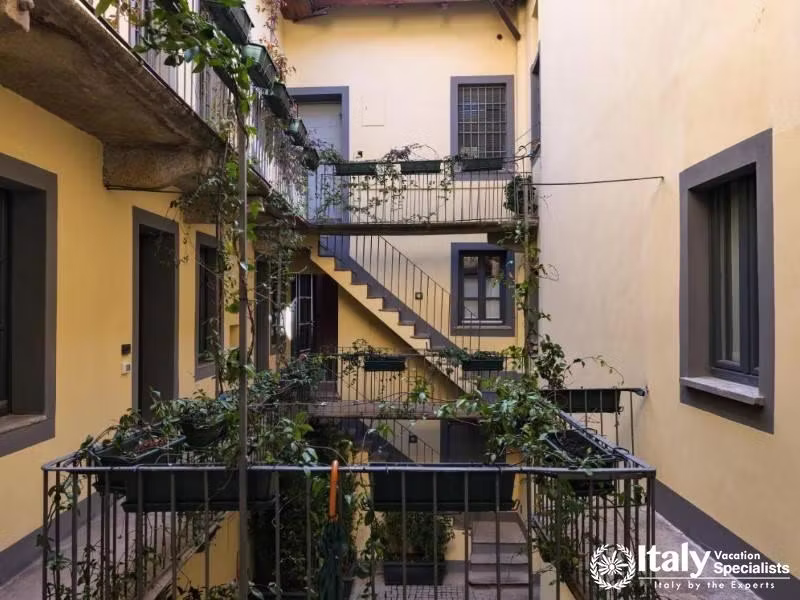Traditional courtyard balconies of Hotel Maison Borella in classic Milanese style.