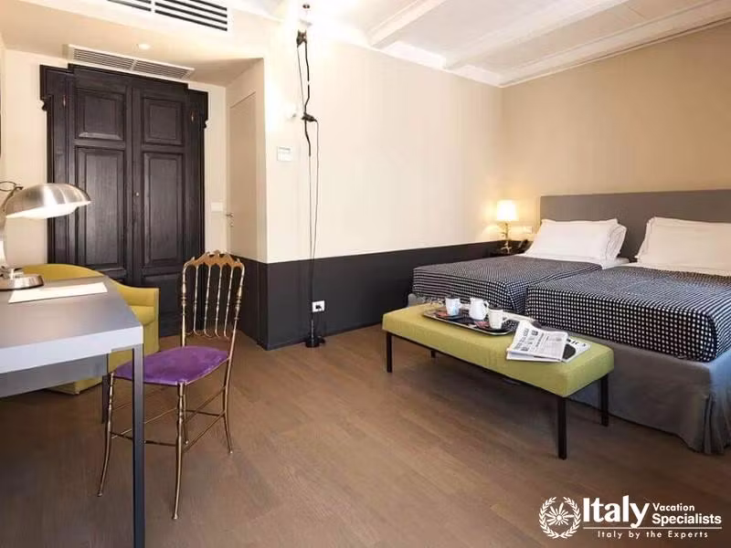 Twin room at Hotel Maison Borella with modern comfort and workspace.