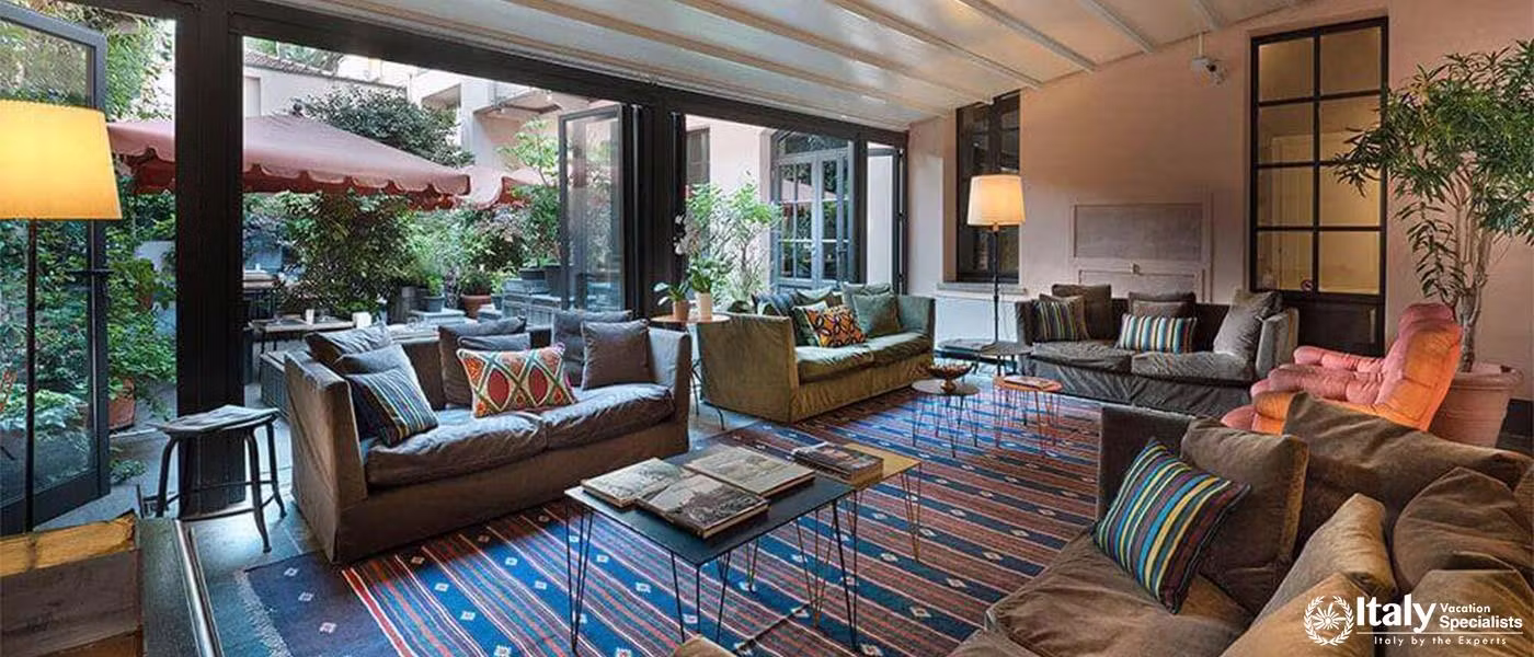 Lounge at Hotel Maison Borella with garden views and vibrant decor.