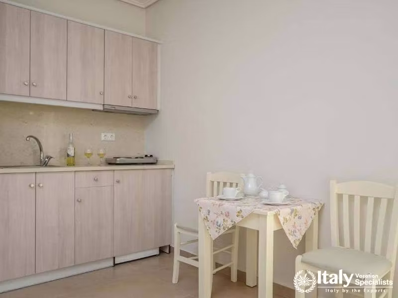 Simple and inviting kitchenette area at Perla Hotel in Naxos, Greece