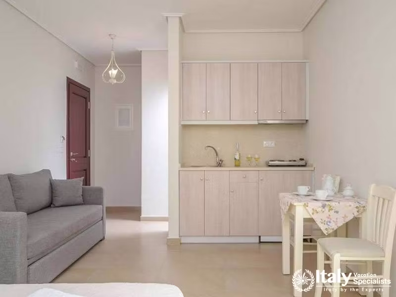 Compact kitchen space with a cozy dining setup at Perla Hotel in Naxos, Greece