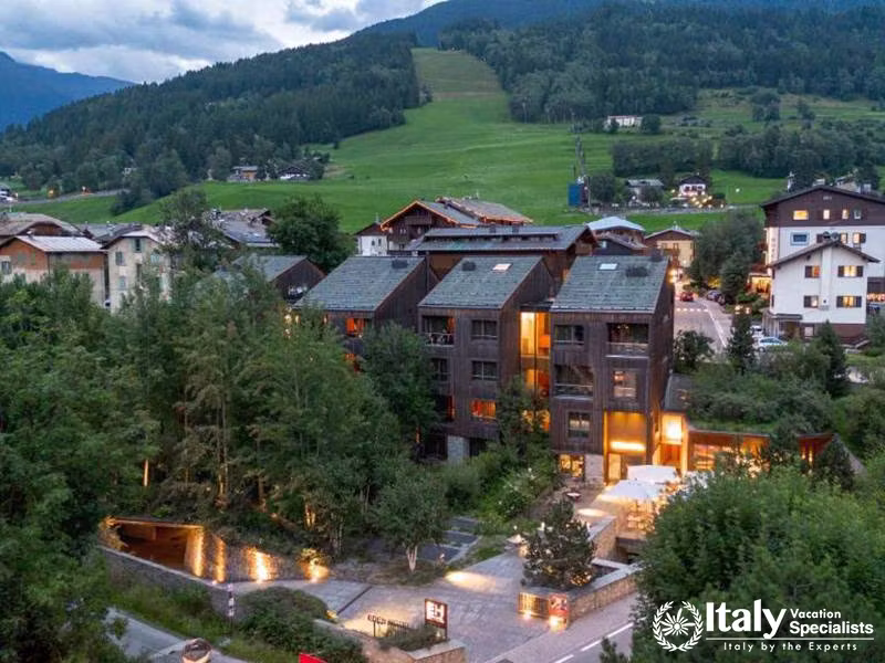 Aerial View of Eden Hotel Surrounded by Mountains and Greenery