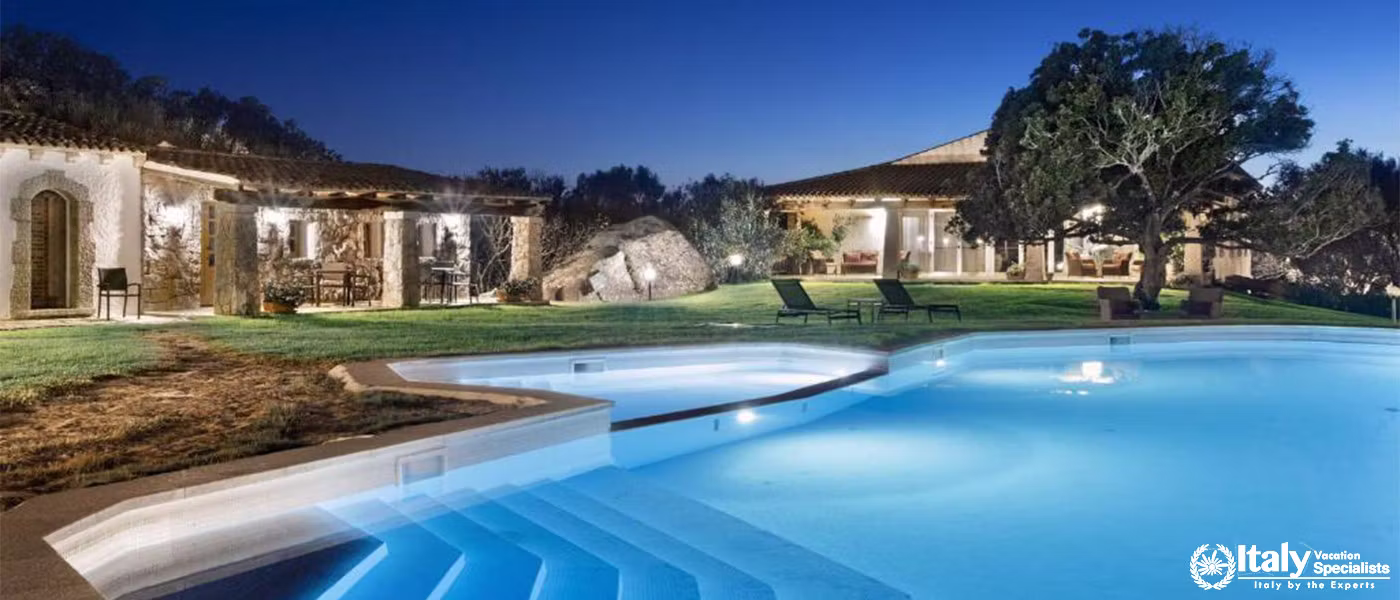 A peaceful evening view of the resort’s outdoor pool and surrounding area