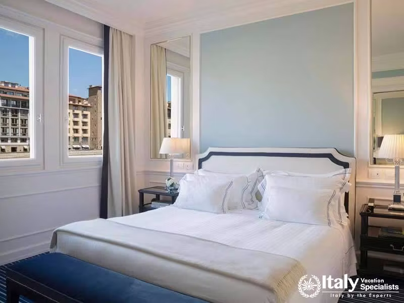 Bright and Airy Bedroom with City Views at Hotel Lungarno in Florence, Italy