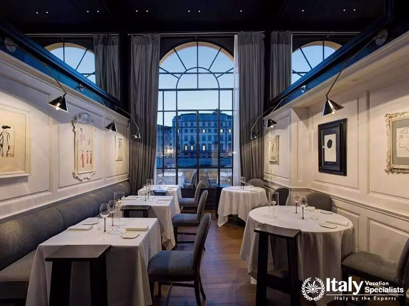Elegant Dining Setting with Riverside View at Hotel Lungarno in Florence, Italy