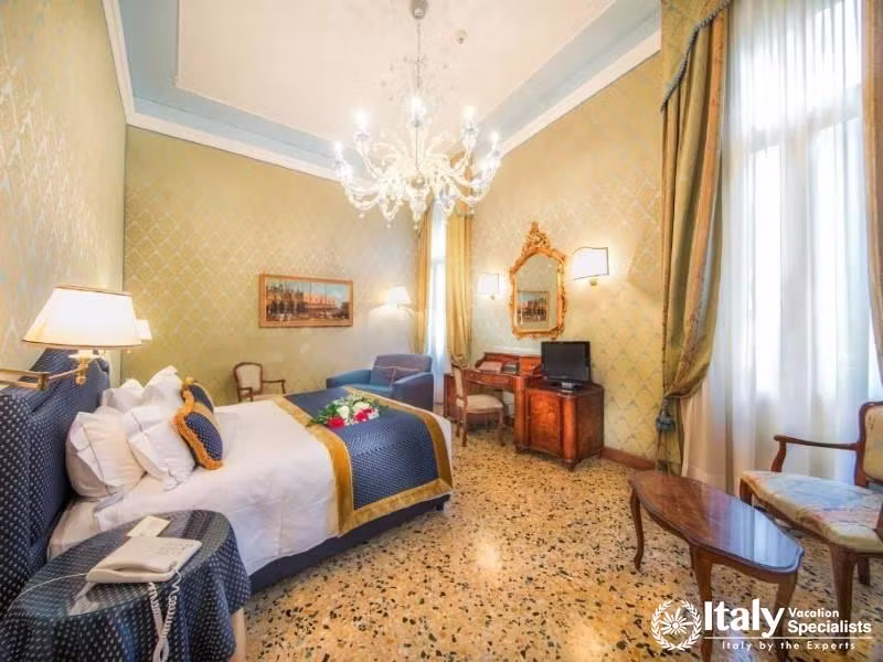 Opulent charm and comfort in a room with a regal touch at Hotel Colombina.
