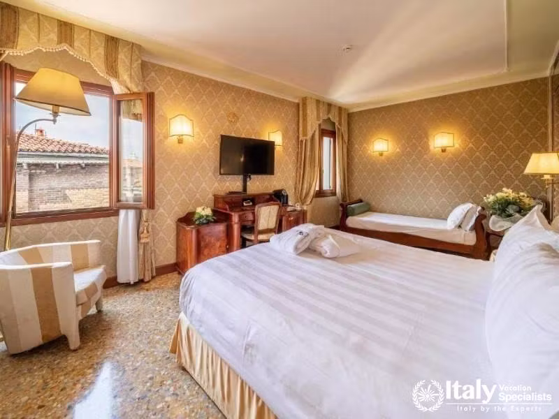 A cozy nook with Venetian charm, overlooking the terracotta rooftops at Hotel Colombina.