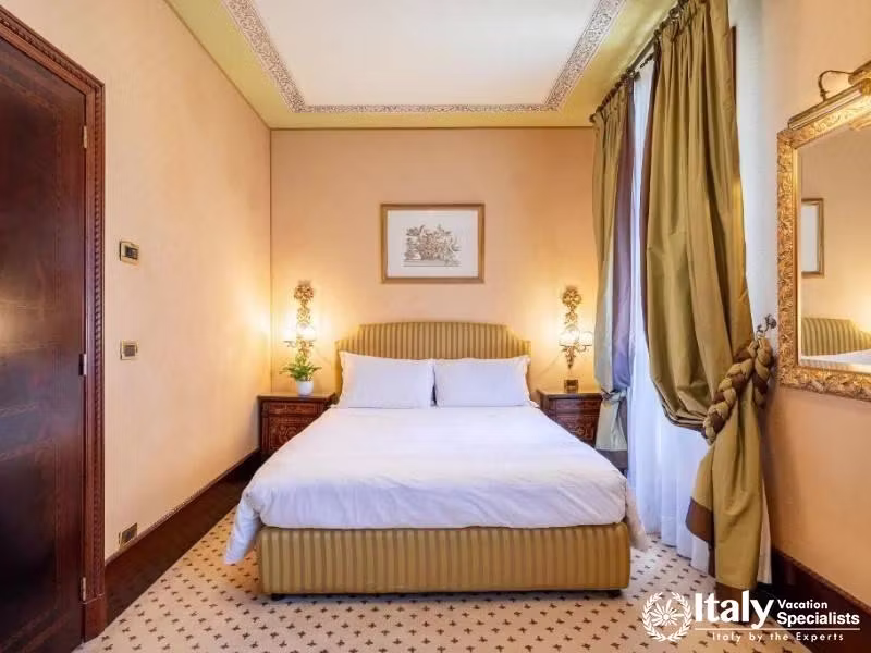 Simplistic elegance and tranquility characterize this peaceful bedroom at Hotel Colombina.
