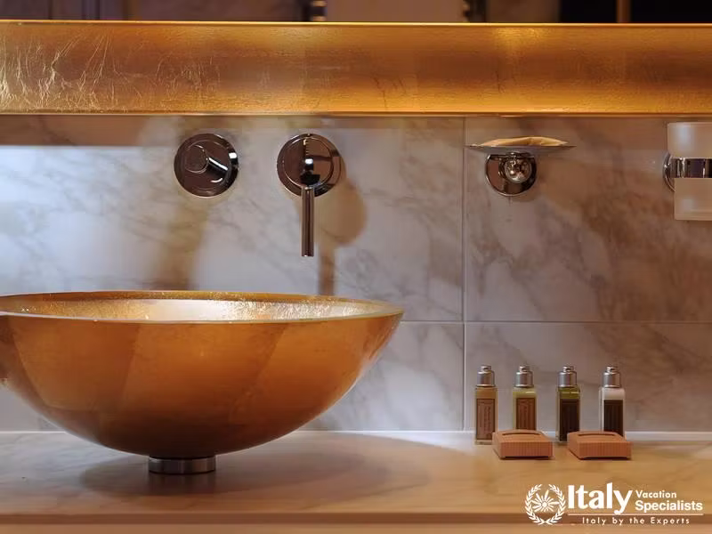 Excellent bathroom with golden interior in Carnival Palace