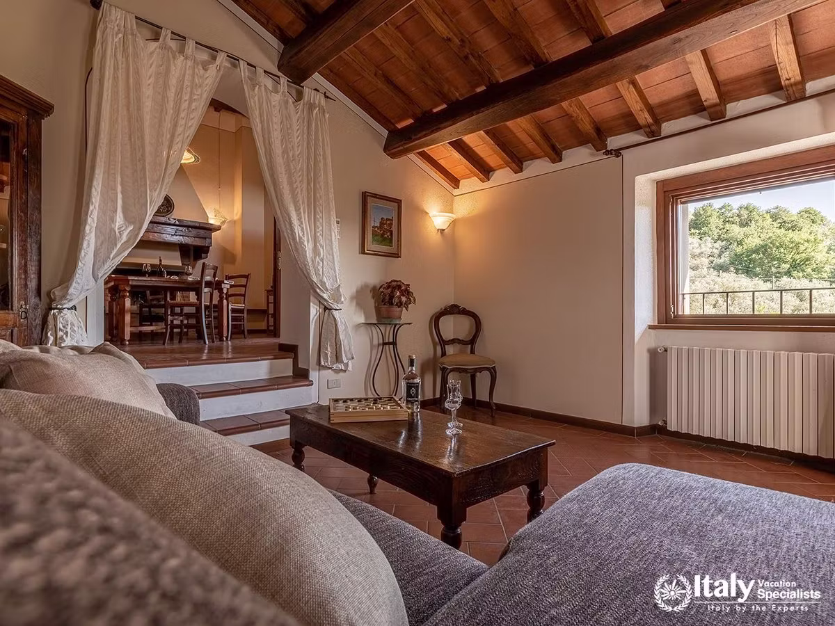 Rustic Living Room with Exposed Wooden Beams at Villa Buccelletti