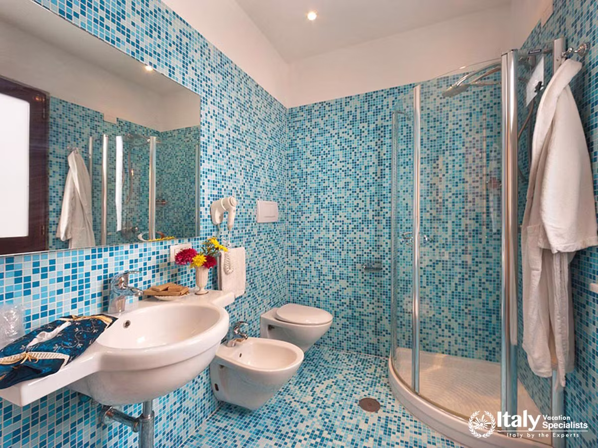 Spacious Mediterranean Bathroom with Blue Mosaic Tiles