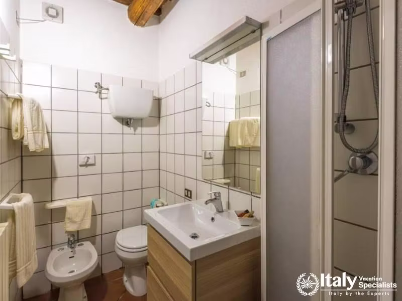 Compact and practical bathroom with a white tile finish.