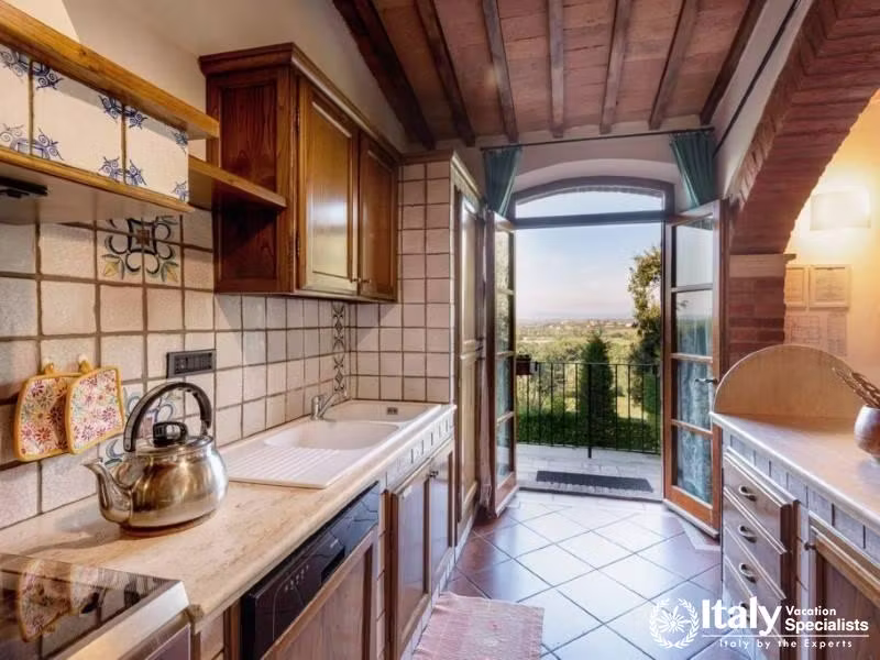 Classic wooden cabinetry and a ceramic backsplash, with a scenic window view.