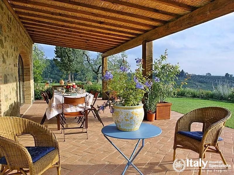 Outdoor dining area with garden view near Florence, Italy.