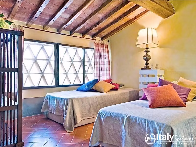 Cozy twin bedroom with rustic decor near Florence, Italy.
