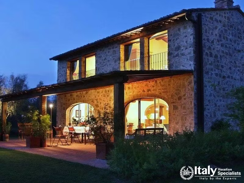 Stone villa illuminated at dusk near Florence, Italy.