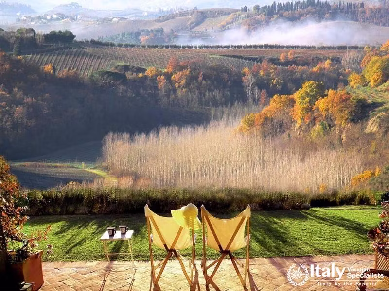 Scenic vineyard view with outdoor seating near Florence, Italy.