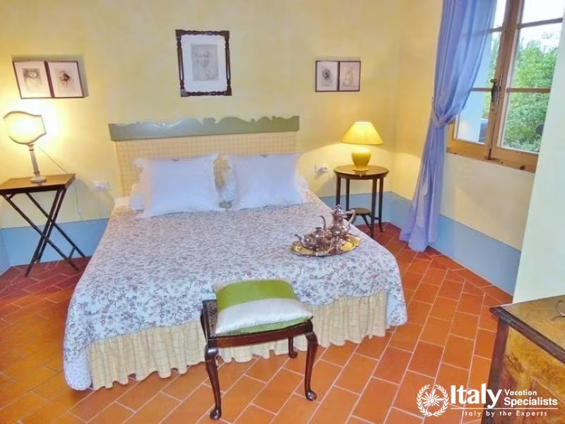 Floral Bedroom: Cozy bedroom with floral bedding and rustic furniture.