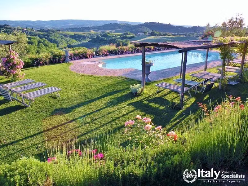 Poolside with lush garden and hillside backdrop.