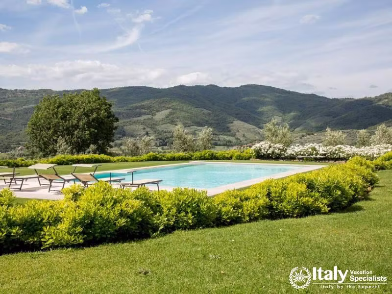 Relaxing Poolside: Bask in the sun by the serene villa pool.