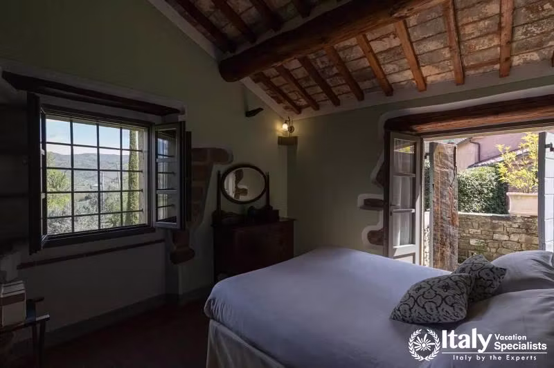 Bedroom View: Wake up to stunning views in a quaint bedroom.