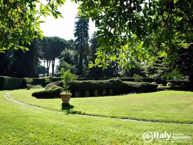 Expansive garden with well-manicured hedges and trees.