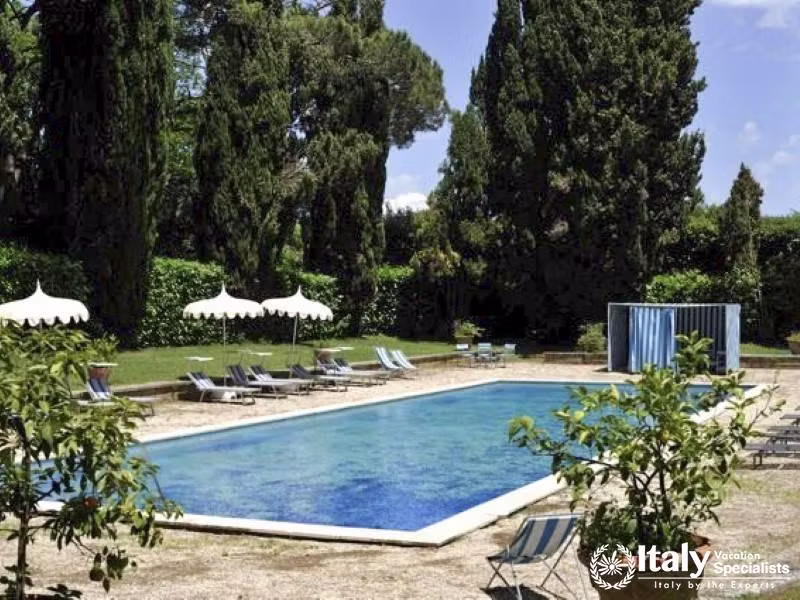 Inviting swimming pool area with lounge chairs and umbrellas.